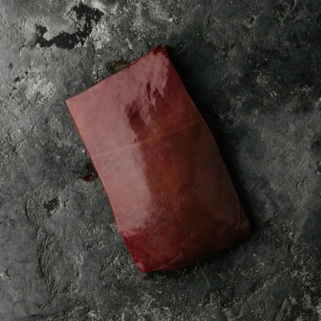 Raw liver on dark surface.